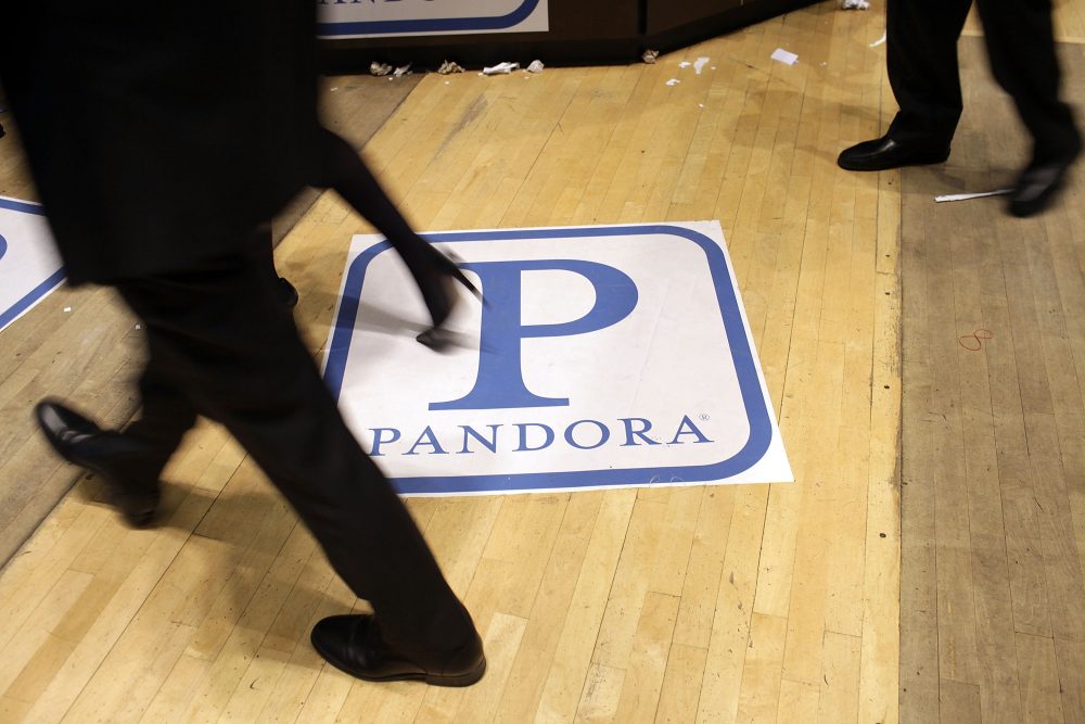 Traders on the floor of the New York Stock Exchange walk over insignia for Pandora Media Inc., the online-radio company, on its first day of trading as a public company on June 15, 2011 in New York City. (Spencer Platt/Getty Images)