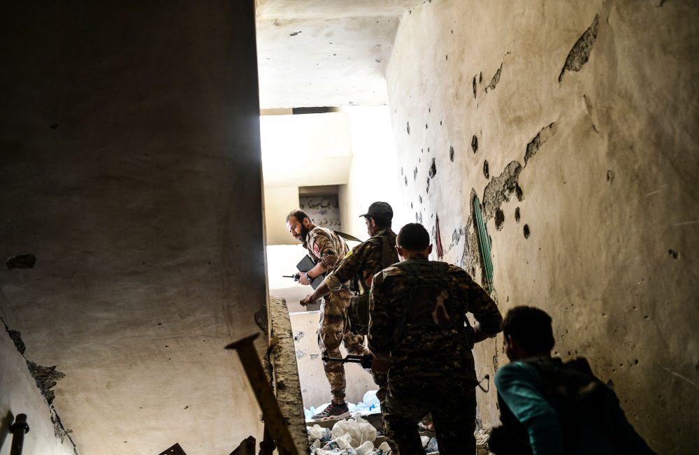 Members of the Syrian Democratic Forces climb up a stairwell during a battle against Islamic State group jihadists to retake the central hospital of Raqqa on the western frontline of the city on Sept. 28, 2017. Syrian fighters backed by U.S. special forces are battling to clear the last remaining Islamic State group jihadists holed up in their crumbling stronghold. (Bulent Kilic/AFP/Getty Images)