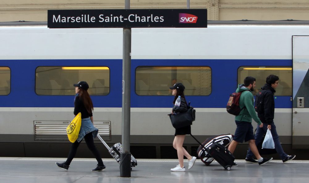 People walk on a platform to take a train, at the Saint-Charles railway station in Marseille, southern France, June, 1, 2016. (Claude Paris/AP)