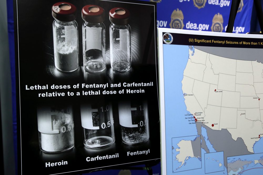 Posters comparing lethal amounts of heroin, fentanyl, and carfentanil, are on display during a news conference in Arlington, Virginia, in June. (Jacquelyn Martin/AP)