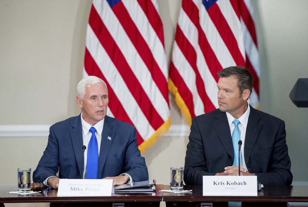 Vice President Mike Pence, left, the chair of the Presidential Advisory Commission on Election Integrity, accompanied by the vice chair, Kansas Secretary of State Kris Kobach, speaks during the commission's first meeting at the White House in July. (Andrew Harnik/AP)
