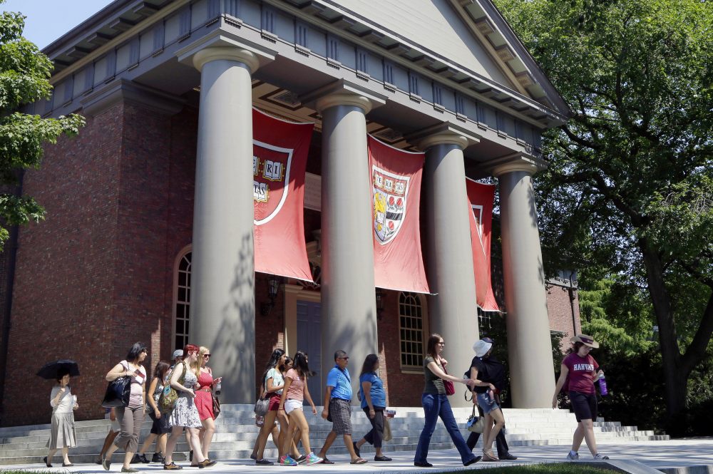In this Aug. 30, 2012, file photo, a tour group walks through the campus of Harvard University. (Elise Amendola/AP)