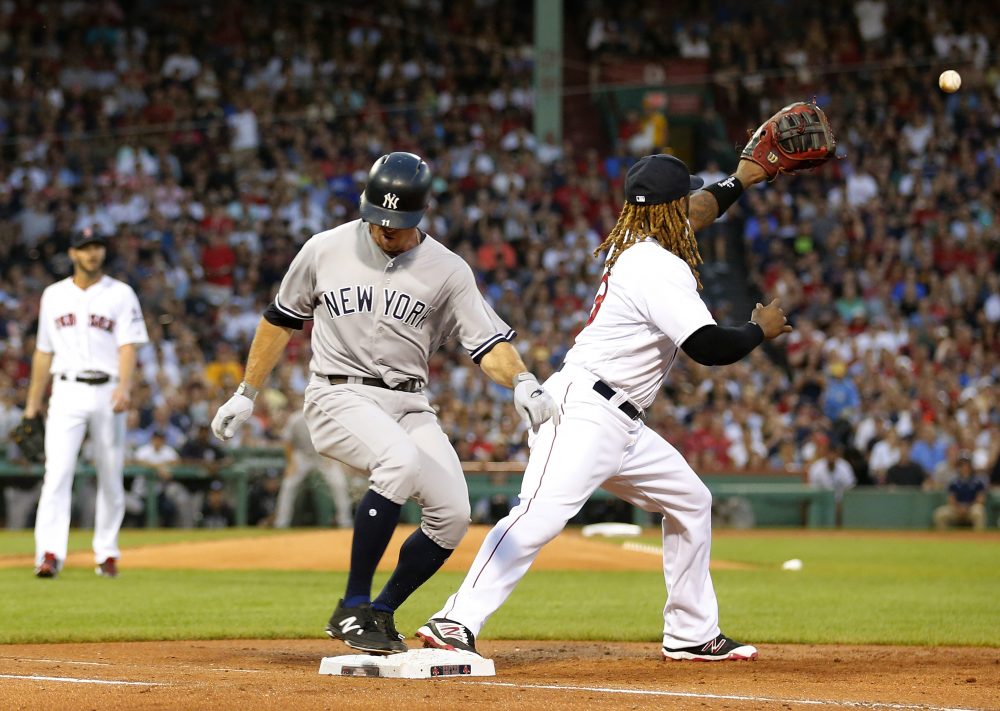 New York Yankees' Brett Gardner beats out an infield hit as Boston Red Sox first baseman Hanley Ramirez awaits the throw during the second inning of a baseball game at Fenway Park in Boston last month. (Winslow Townson/AP)