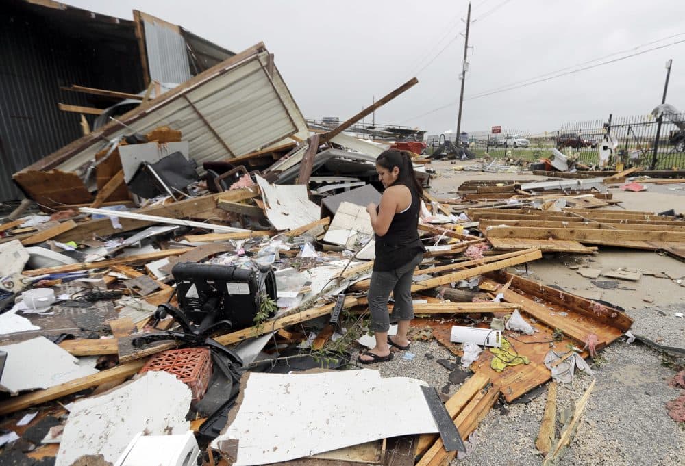Jennifer Bryant looks over the debris from her family business destroyed by Hurricane Harvey Saturday, Aug. 26, 2017, in Katy, Texas. (David J. Phillip/AP)