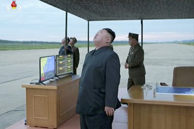 In this image made from video of a news bulletin aired by North Korean government broadcaster KRT on Wednesday, Aug. 30, 2017, leader Kim Jong Un looks up at the sky at what is said to have been a missile launch on Aug. 29, 2017, at an undisclosed location in North Korea. (KRT via AP Video)