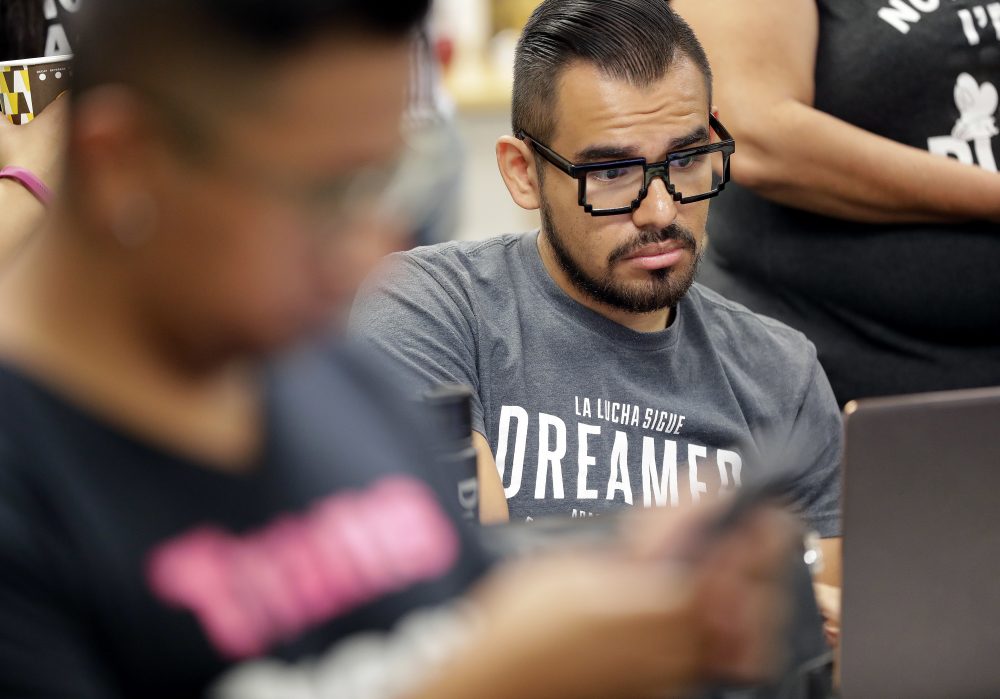 Diego Lozano watches the coverage moments after U.S. Attorney General Jeff Sessions' announcement that the Deferred Action for Childhood Arrivals (DACA), will be suspended with a six-month delay, Tuesday, Sept. 5, 2017, in Phoenix. President Donald Trump on Tuesday began dismantling the Deferred Action for Childhood Arrivals, or DACA, program, the government program protecting hundreds of thousands of young immigrants who were brought into the country illegally as children. (Matt York/AP)