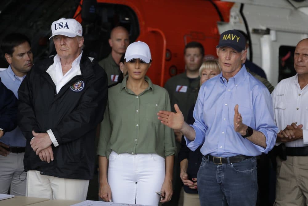 President Donald Trump, first lady Melania Trump, center, and Gov Rick Scott- R Fla., right, participate in a briefing on the Hurricane Irma relief efforts, Thursday, Sept. 14, 2017, in Ft. Myers, Fla., at Southwest Florida International airport. (Evan Vucci/AP)