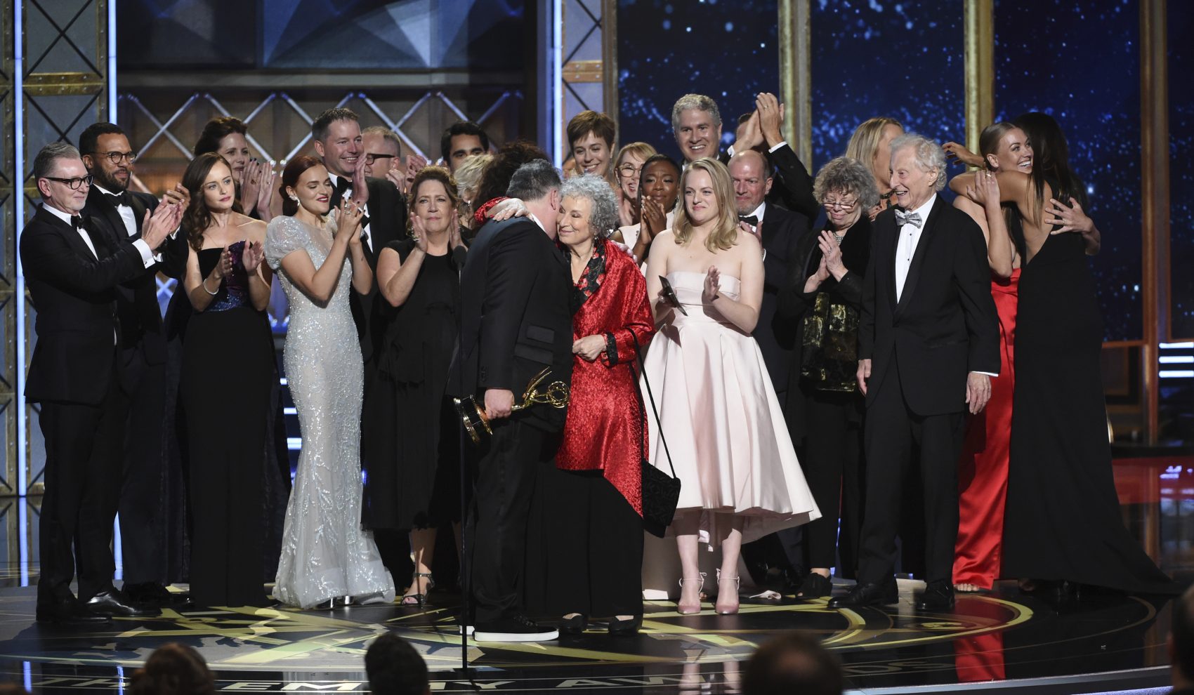Bruce Miller, left, embraces author Margaret Atwood after accepting the Emmy for outstanding drama for &quot;The Handmaid's Tale.&quot; (Phil McCarten/Invision for the Television Academy/AP)