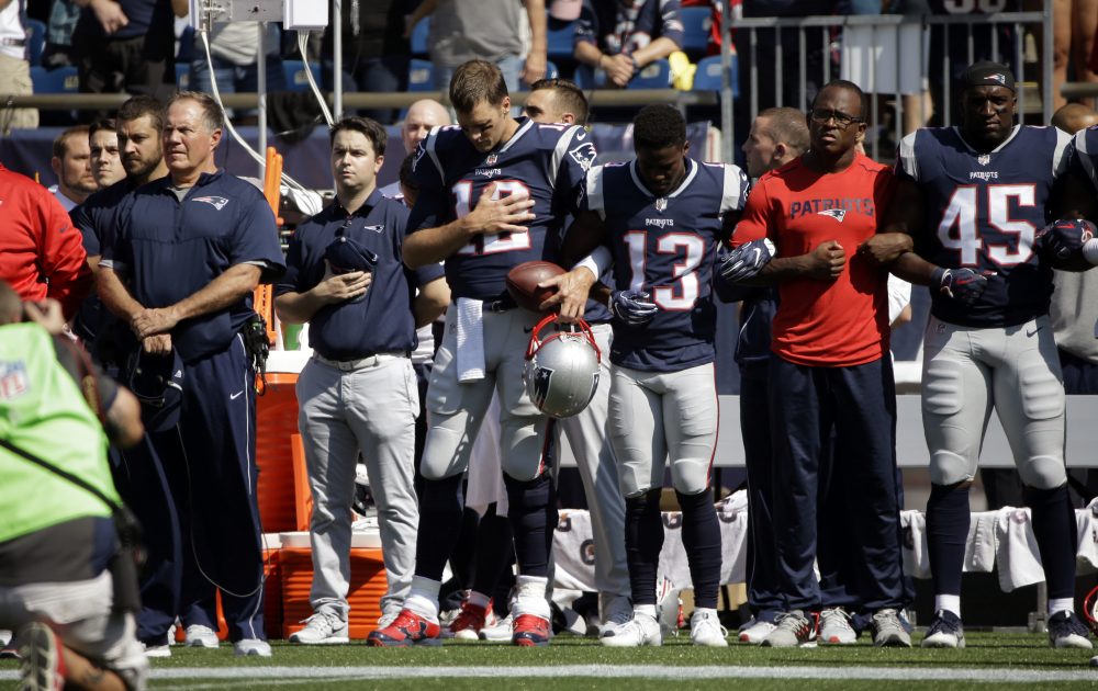 Patriots head coach Bill Belichick, left, and Tom Brady (12), Phillip Dorsett (13), Matthew Slater, second from right, and David Harris (45) stand during the national anthem before Sunday's game against the Texans. (Steven Senne/AP)