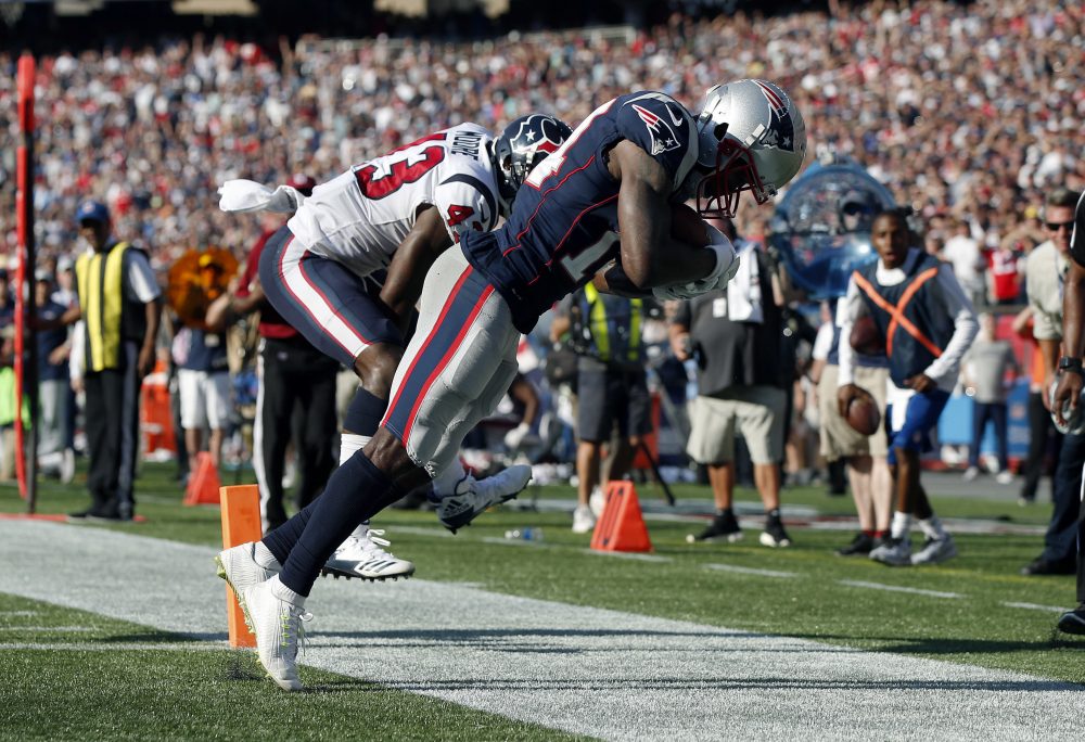 Patriots wide receiver Brandin Cooks drags his toes as he makes the game-winning catch in the end zone for a touchdown in front of Houston Texans safety Corey Moore, Sunday in Foxborough. The Patriots won 36-33. (Michael Dwyer/AP)
