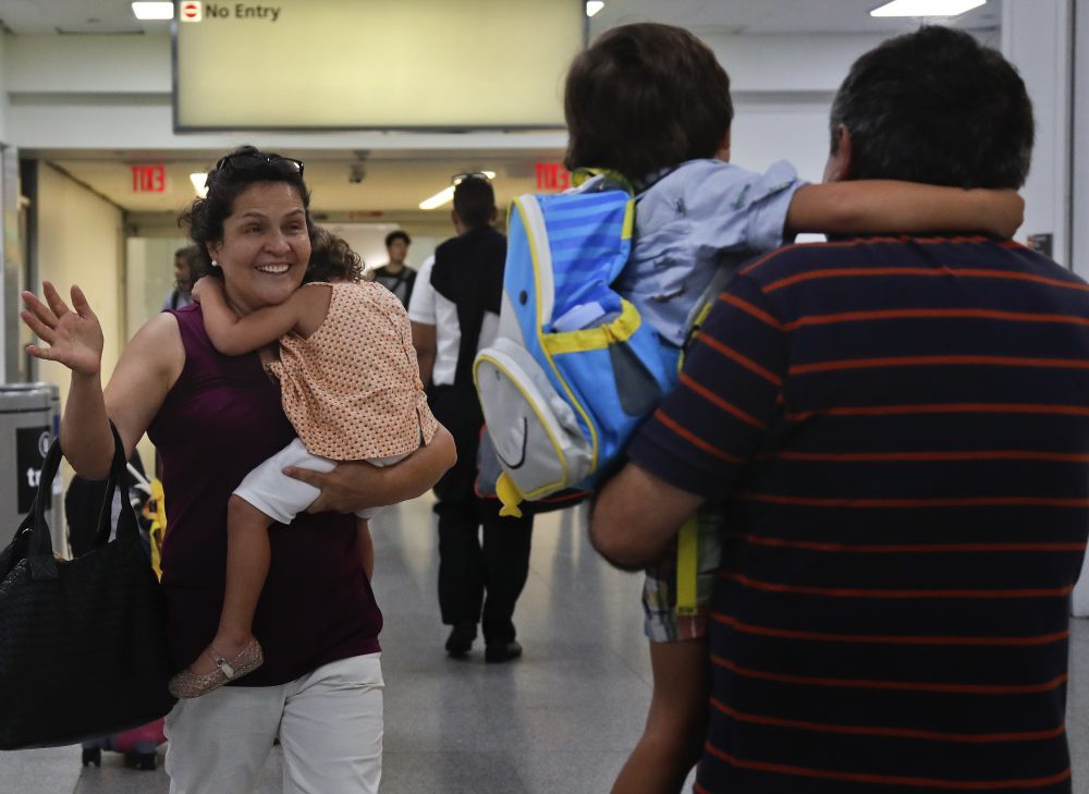 Elena Rojas, left, of Queens, N.Y., reacts as she greets her 4-year-old grandson Elias while carrying her 3-year-old granddaughter Lilly after the children arrived at JFK Airport Tuesday from Puerto Rico with their mother Cori Rojas (not pictured). Cori Rojas and her children fled Puerto Rico after Hurricane Maria devastated the island and will stay in Queens. (Julie Jacobson/AP)