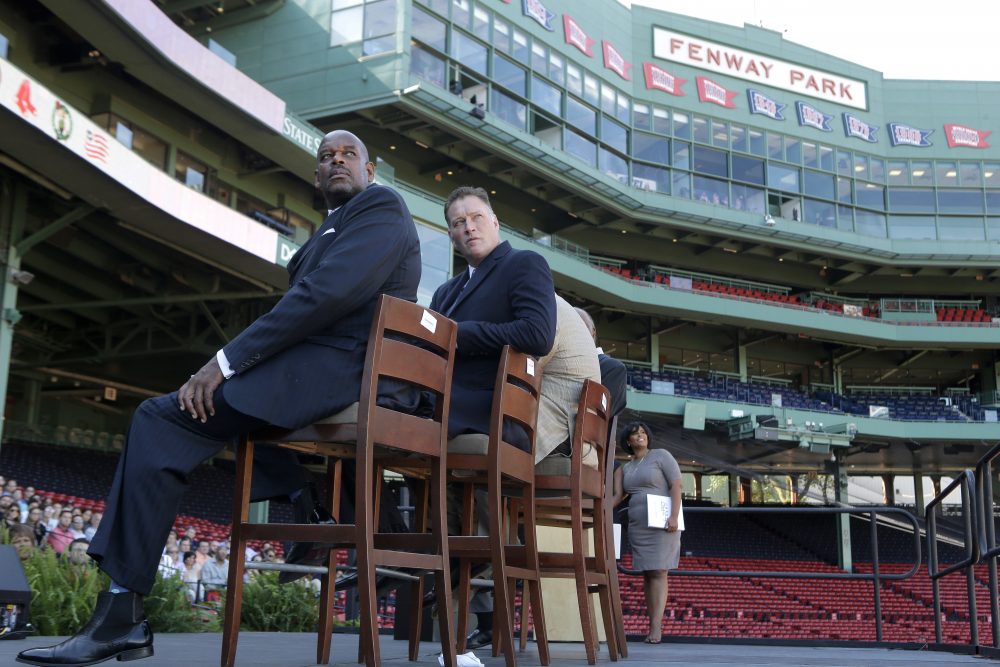 Cedric Maxwell, former Boston Celtics player and Bob Sweeney, executive director of the Boston Bruins Foundation, look toward a video screen during a panel discussion held to introduce an initiative called &quot;Take The Lead&quot; Thursday at Fenway Park. (Steven Senne/AP)