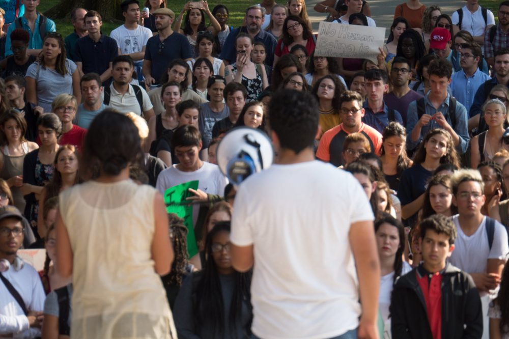 Bruno Villegas and another student speak about DACA before a crowd in Harvard Yard. (Max Larkin/WBUR)