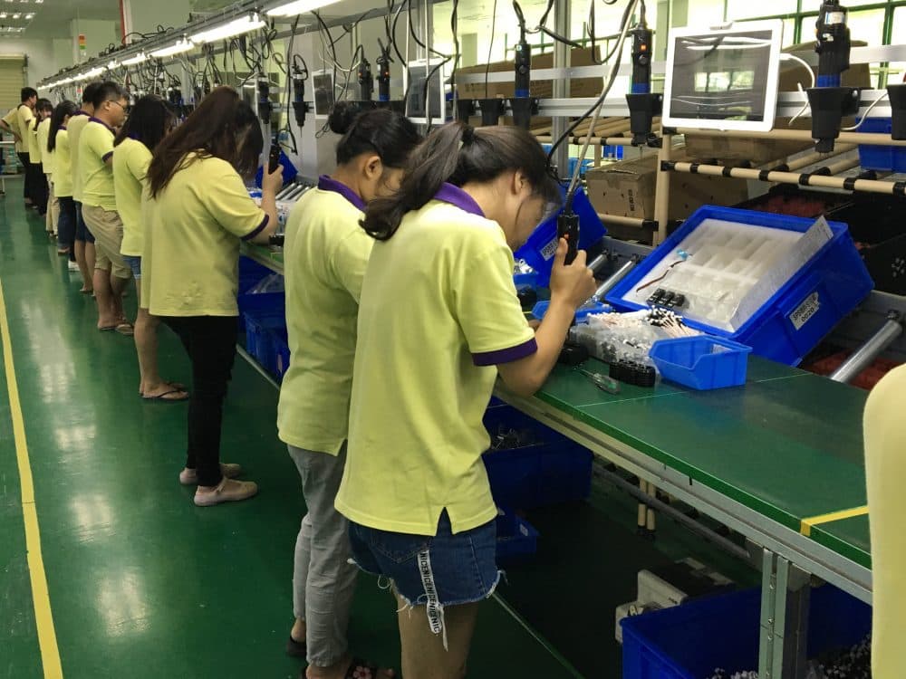 Chinese workers at a robot factory in Shenzhen, China. (Asma Khalid, WBUR)