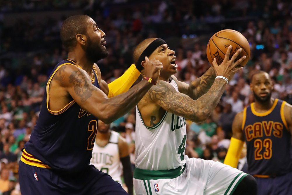 Isaiah Thomas, formerly of the Boston Celtics, drives to the basket against Kyrie Irving, formerly of the Cleveland Cavaliers, in the 2017 NBA playoffs. The players have swapped jerseys after a recent blockbuster trade. (Photo by Elsa/Getty Images)