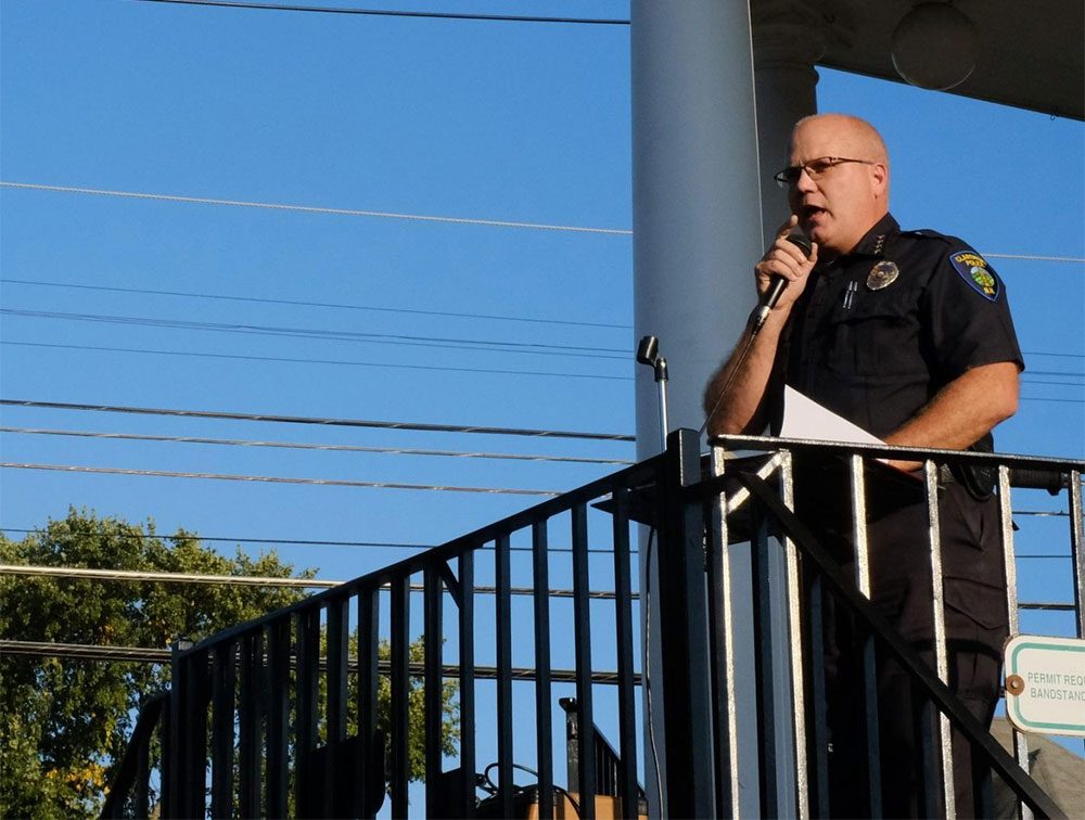 Claremont Police Chief Mark Chase speaks during the vigil. (Britta Greene/NHPR)