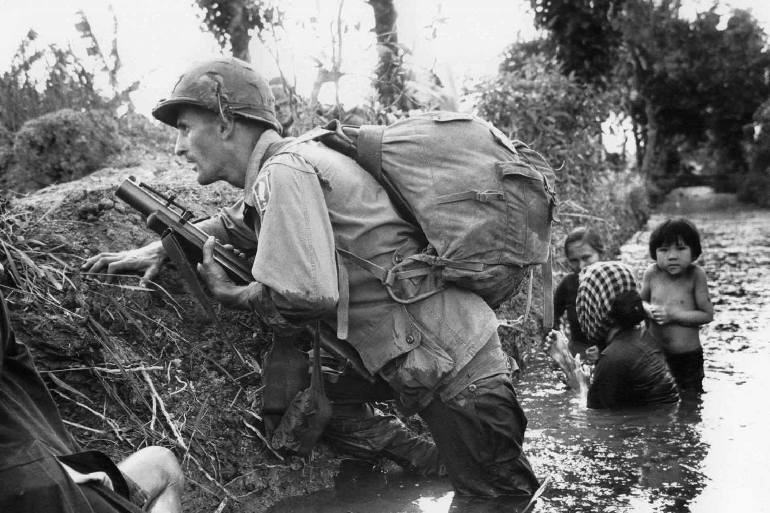 Long Khanh Province, Republic of Vietnam: SP4 R. Richter, 4th Battalion, 503rd Infantry, 173rd Airborne Brigade, lifts his battle weary eyes to the heavens, as if to ask why? Sergeant Daniel E. Spencer stares down at their fallen comrade. The day's battle ended, the silently await the helicopter which will evacuate their comrade from the jungle covered hills. (Courtesy of National Archives and Records Administration)