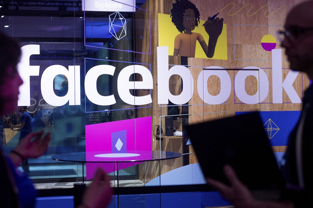 In this April 18, 2017 photo, conference workers speak in front of a demo booth at Facebook's annual F8 developer conference in San Jose, Calif.  (Noah Berger/AP)