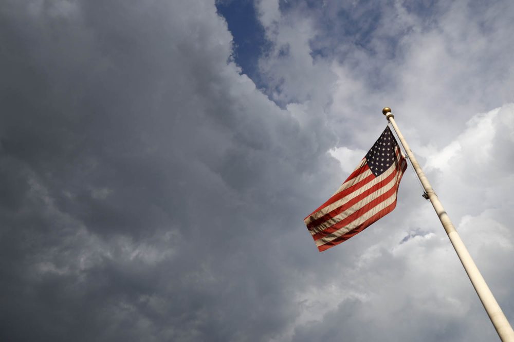 An American flag flaps in the wind in Denver. (David Zalubowski/AP)