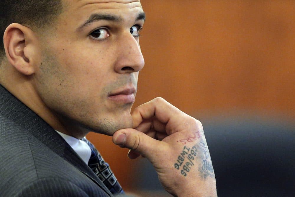Former New England Patriots NFL football player Aaron Hernandez listens as prosecution witness Alexander Bradley testifies during his murder trial, Wednesday, April 1, 2015, at Bristol County Superior Court in Fall River, Mass. (Brian Snyder/AP)