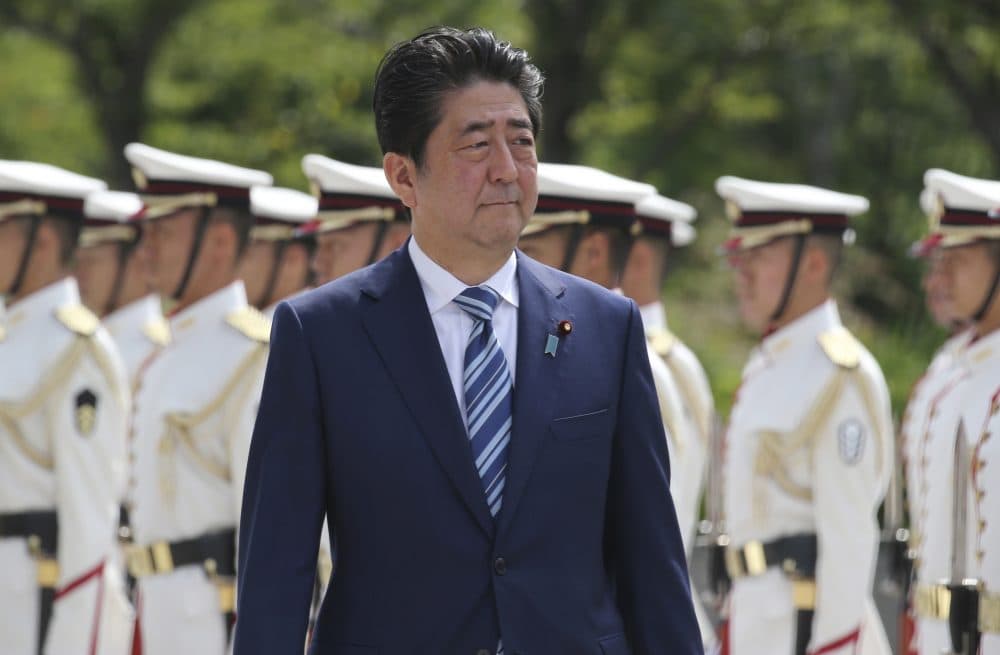 Japanese Prime Minister Shinzo Abe inspects an honor guard during the Japan Self-Defense Forces senior officers' gathering at Defense Ministry in Tokyo. (Koji Sasahara/AP)