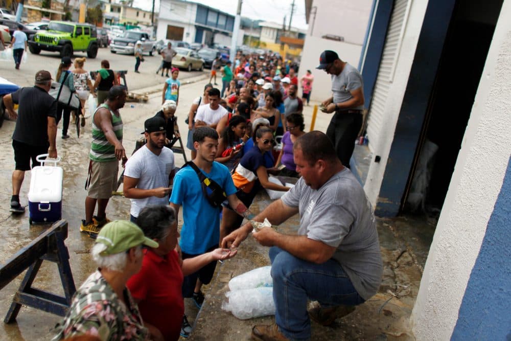 Hundreds of people line up to buy ice at a local plant in the aftermath of Hurricane Maria, in Arecibo, Puerto Rico, Sept. 30, 2017. (Ricardo Arduengo/AFP/Getty Images)