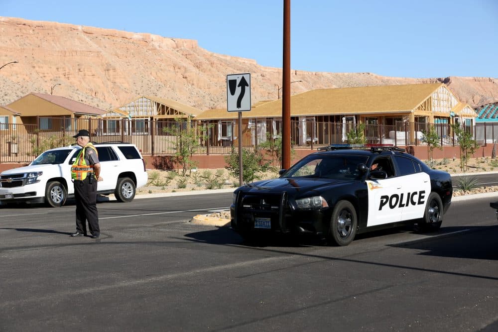 A Mesquite Police Department citizen volunteer and a Mesquite Police car block access to the Sun City Mesquite community where suspected Las Vegas gunman Stephen Padock lived on Oct. 2, 2017, in Mesquite, Nev. (Gabe Ginsberg/Getty Images)