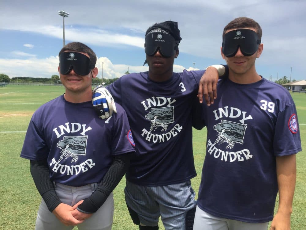 Indy Thunder players pose with their blindfolds. (Allison Light/WLRN News)