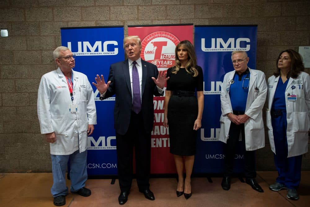 Flanked by surgeon Dr. John Fildes (left) and first lady Melania Trump, President Trump speaks to reporters at University Medical Center, Oct. 4, 2017, in Las Vegas. (Drew Angerer/Getty Images)