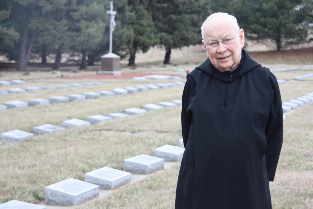 Father Dennis Meade in the abbey cemetery. The Benedictine Monks of Atchison established the monastery in Atchison, Kansas right around the time the state was opening for settlement. (Laura Ziegler/KCUR)