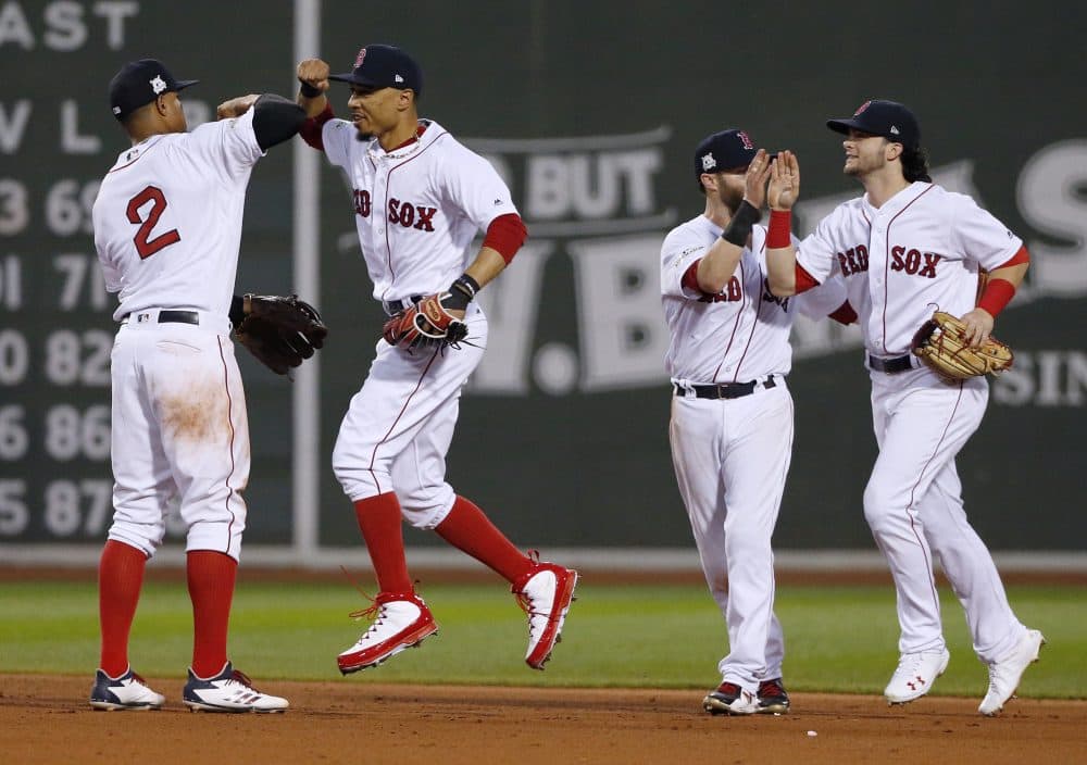 Boston Red Sox's Xander Bogaerts, left, Mookie Betts, second from left, Dustin Pedroia, second from right, and Andrew Benintendi, right, celebrate their 10-3 win over the Houston Astros in Game 3 of baseball's American League Division Series, Sunday, Oct. 8, 2017, in Boston. (Michael Dwyer/AP)