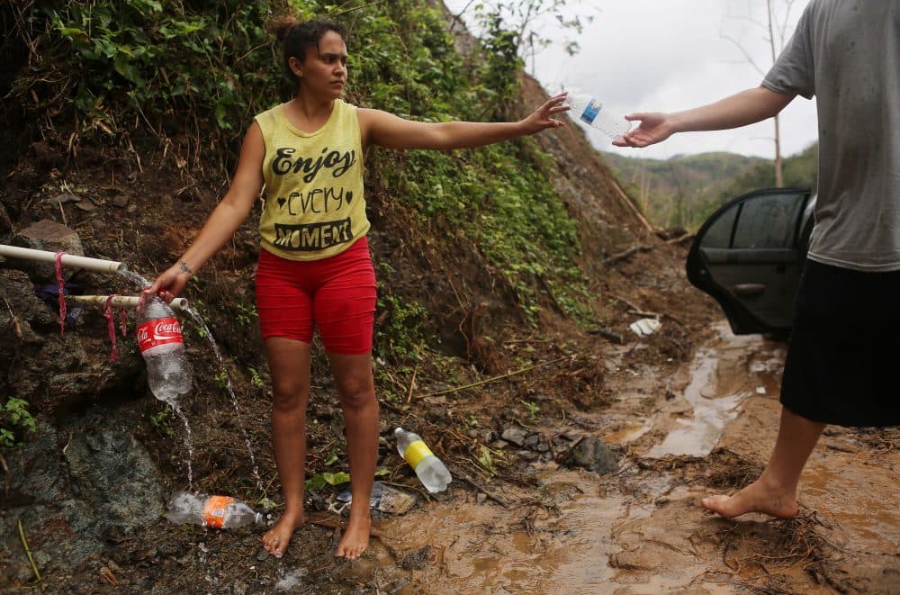 Yanira Rios collects spring water for her house nearly three weeks after Hurricane Maria hit Puerto Rico, on Oct. 10, 2017 in Utuado, Puerto Rico. Her house and most of the municipality is without running water or grid power. (Mario Tama/Getty Images)