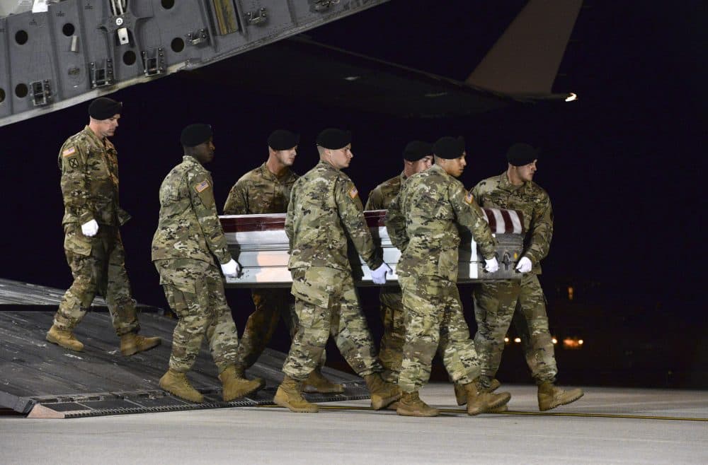 In this image provided by the U.S. Air Force, a U.S. Army carry team transfers the remains of Army Staff Sgt. Dustin Wright of Lyons, Ga., late Thursday, Oct. 5, 2017, upon arrival at Dover Air Force Base, Del. Wright, 29, of Lyons, Ga., was one of four U.S. troops and four Niger forces killed in an ambush by dozens of Islamic extremists on a joint patrol of American and Niger Force. (Staff Sgt. Aaron J. Jenne/U.S. Air Force via AP)