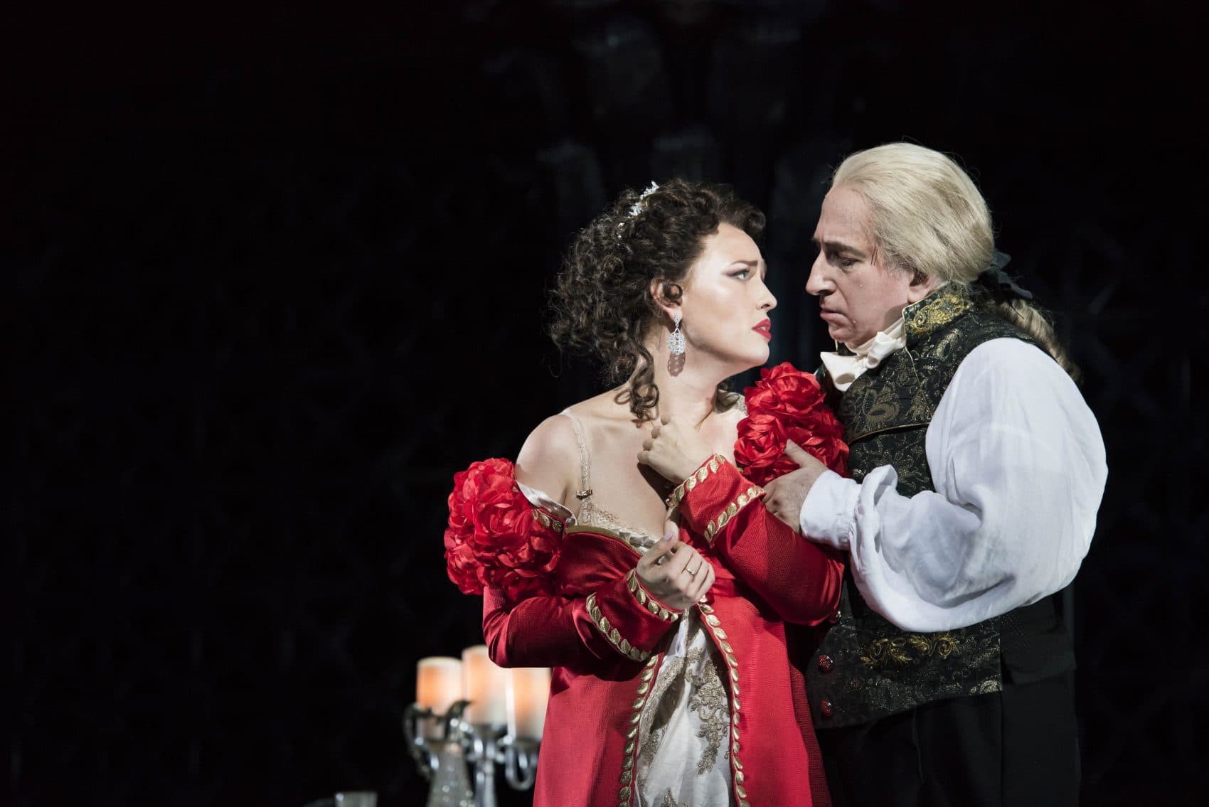 Tosca, portrayed by Elena Stikhina, submits to Scarpia, played by Daniel Sutin, to save the life of her true love in the Boston Lyric Opera production of &quot;Tosca.&quot; (Courtesy Liza Voll/Boston Lyric Opera)