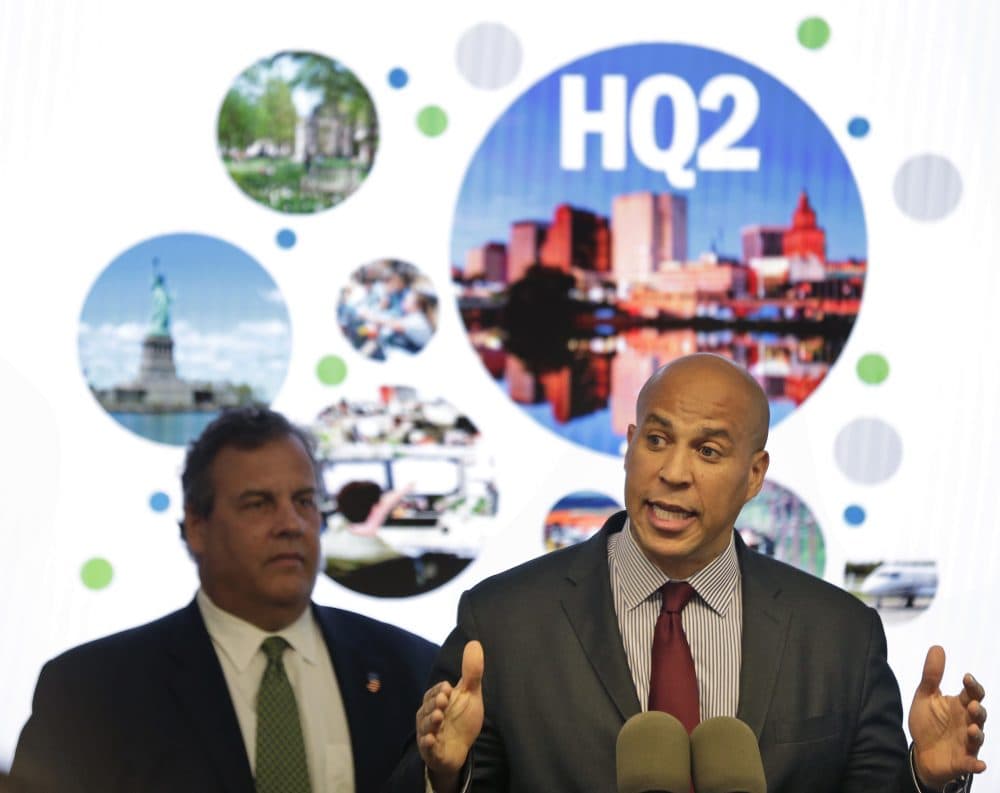 New Jersey Sen. Cory Booker, right, speaks while New Jersey Gov. Chris Christie stands behind him during an announcement in Newark, N.J., Monday, Oct. 16, 2017. The New Jersey lawmakers announced they are submitting a bid to Amazon that Newark would be the best location for their planned second headquarters. (Seth Wenig/AP)