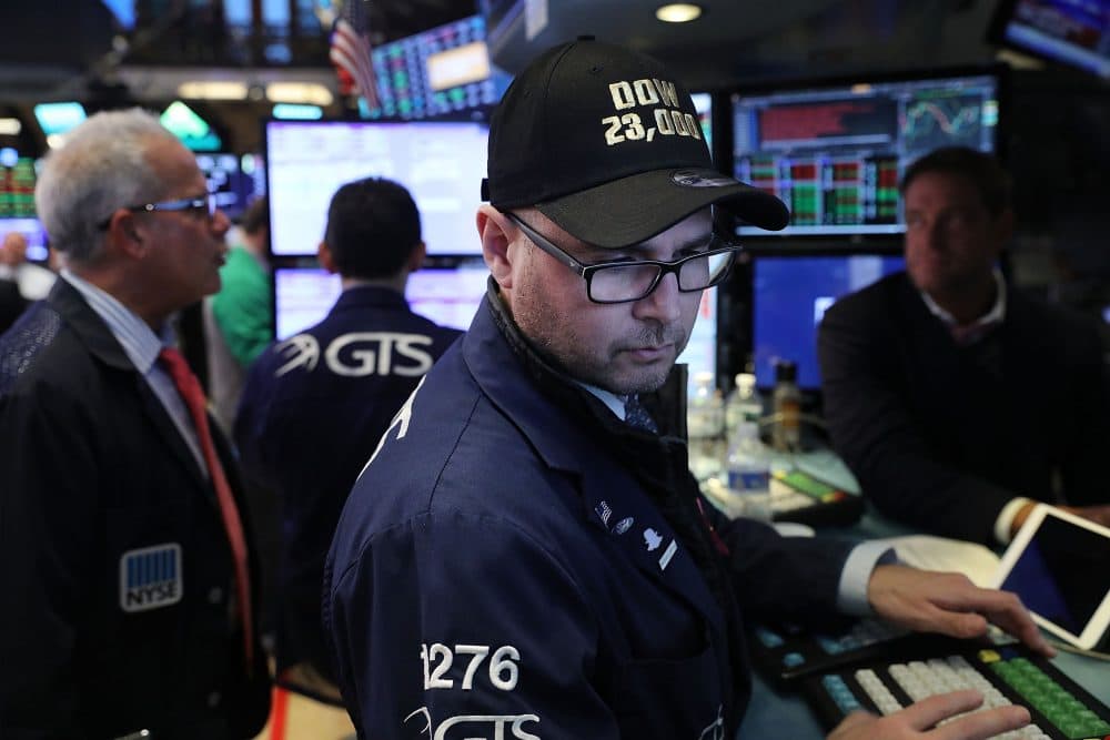 A trader wears a hat reading Dow 23,000 on the floor of the New York Stock Exchange (NYSE) on Oct. 17, 2017 in New York City. (Spencer Platt/Getty Images)