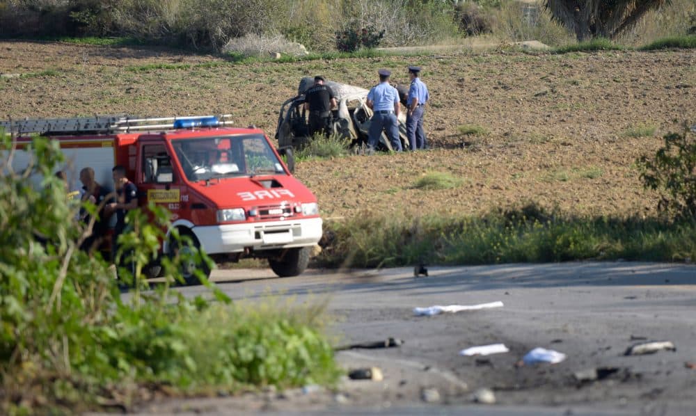 Police inspect the wreckage of a car bomb believed to have killed journalist and blogger Daphne Caruana Galizia close to her home in Bidnija, Malta on Oct. 16, 2017. The force of the blast broke her car into several pieces and catapulted the journalist's body into a nearby field, witnesses said. She leaves a husband and three sons. Caruana Galizia's death comes four months after Prime Minister Joseph Muscat's Labour Party won a resounding victory in a general election he called early as a result of scandals to which Caruana Galizia's allegations were central. (Str/AFP/Getty Images)
