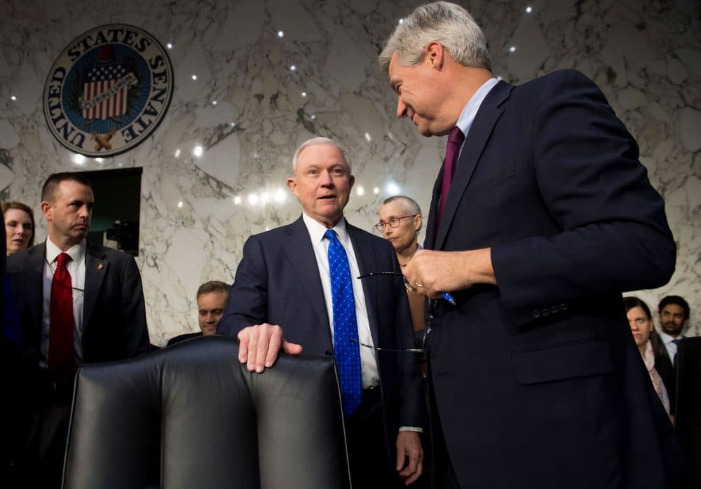 Attorney General Jeff Sessions (center) speaks with Democratic Sen. Sheldon Whitehouse of Rhode Island as he arrives to testify during a Senate Judiciary Committee hearing on Capitol Hill on Oct. 18, 2017. (Saul Loeb/AFP/Getty Images)