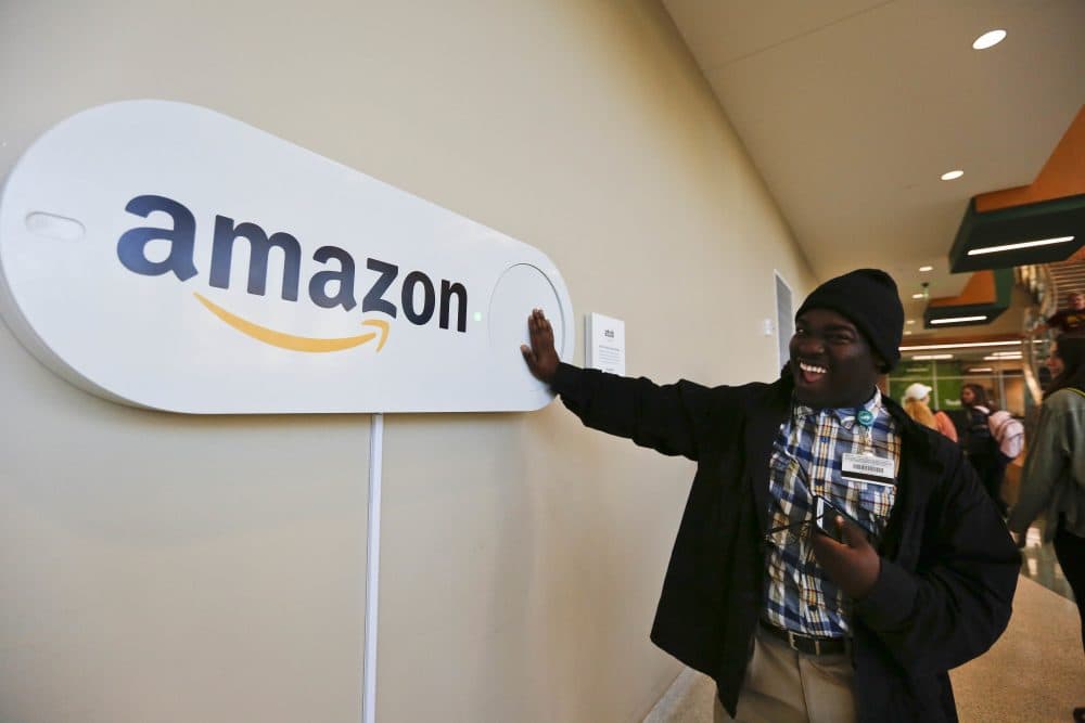 In this Monday, Oct. 16, 2017, photo, Zavian Tate, a student at the University of Alabama at Birmingham, pushes a large Amazon Dash button, in Birmingham, Ala. The large Dash buttons are part of the city's campaign to lure Amazon's second headquarters to Birmingham. (Brynn Anderson/AP)