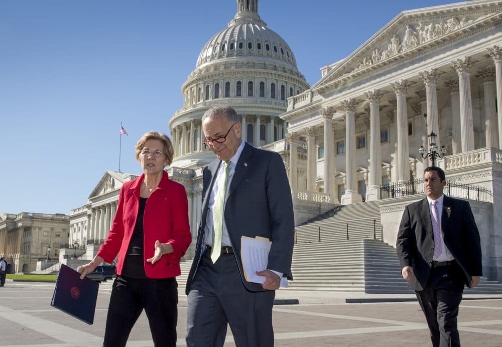 Sen. Elizabeth Warren, D-Mass., left, and Senate Minority Leader Chuck Schumer, D-N.Y., walk to a news conference on the Republican tax and budget proposals, at the Capitol in Washington, Wednesday, Oct. 18, 2017. (J. Scott Applewhite/AP)