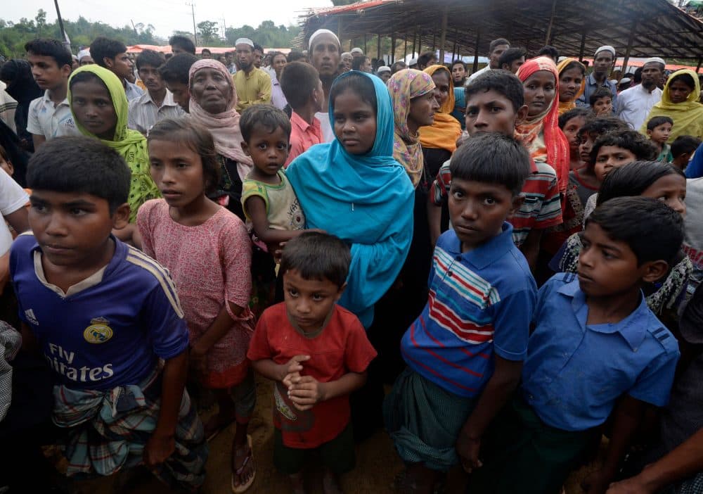 Rohingya Muslim refugees wait for relief supplies at Thaingkhali refugee camp in Ukhia on Oct. 20, 2017. Some 582,000 Rohingya refugees have fled their homes in Myanmar and arrived in Bangladesh since late August, the United Nations said Oct. 17, warning that thousands more were stranded at the border. (Tauseef Mustafa/AFP/Getty Images)