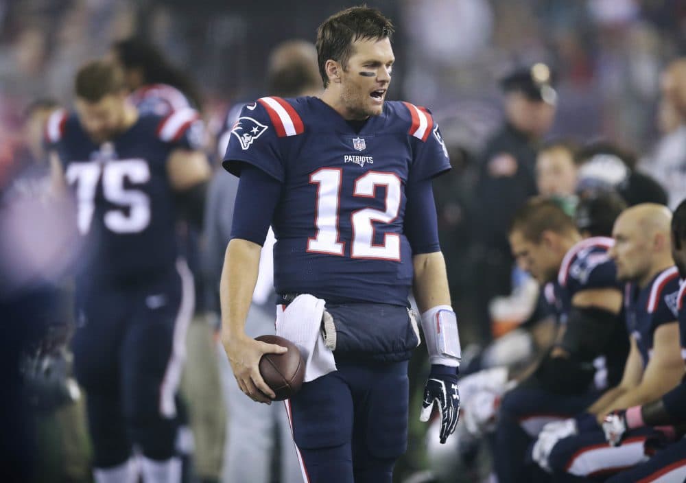 New England Patriots quarterback Tom Brady talks to teammates on the sideline during the second half. (Charles Krupa/AP)