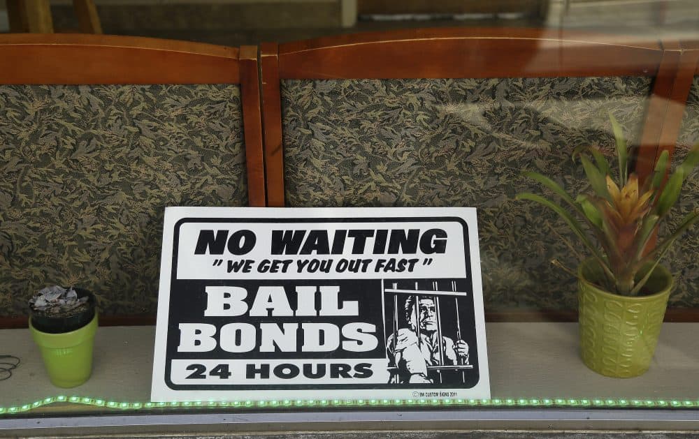 In this photo taken Wednesday, Dec. 23, 2015, a sign is seen in the window of a bail bonds office across from the Hall of Justice in San Francisco. (Eric Risberg/AP)