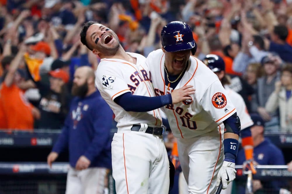 Jose Altuve and Yuli Gurriel of the Houston Astros celebrate after a two-run home run by Carlos Correa during the seventh inning against the Los Angeles Dodgers in Game 5 of the 2017 World Series at Minute Maid Park on Oct. 29, 2017 in Houston, Texas. (Jamie Squire/Getty Images)