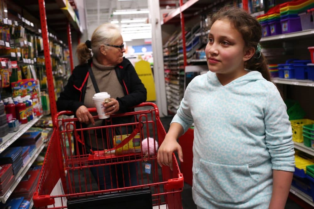 Mellanie Rodriguez, Francisco Rodriguez's 10-year-old daughter, goes shopping for school supplies with her grandmother, Jesus Rodriguez, on Saturday. (Hadley Green for WBUR)