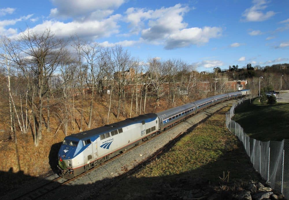 In this Dec. 8, 2011 photo, the Amtrak Downeaster travels through Portland, Maine. (Robert F. Bukaty/AP)