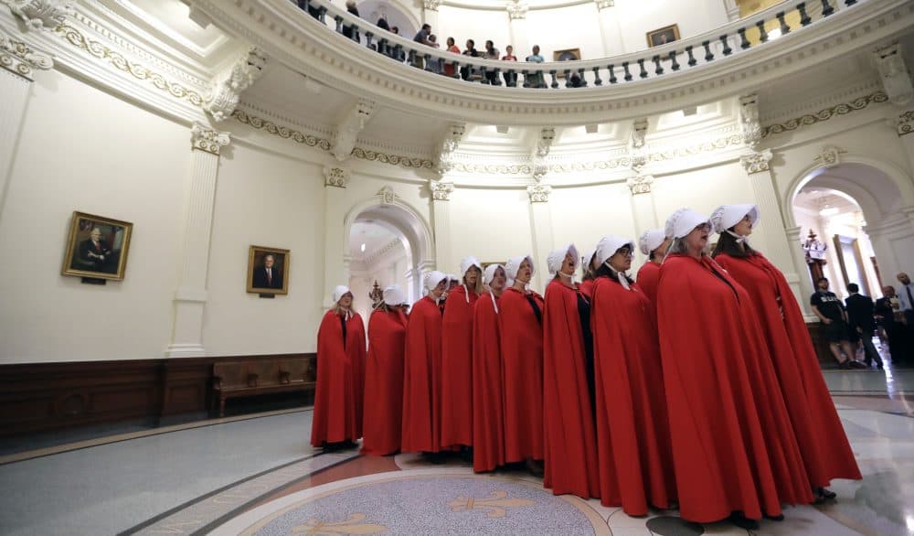 Activists dressed as characters from &quot;The Handmaid's Tale&quot; chant in the Texas Capitol Rotunda as they protest SB8, a bill that would require health care facilities, including hospitals and abortion clinics, to bury or cremate any fetal remains whether from abortion, miscarriage or stillbirth, and they would be banned from donating aborted fetal tissue to medical researchers, Tuesday, May 23, 2017, in Austin. (Eric Gay/AP)