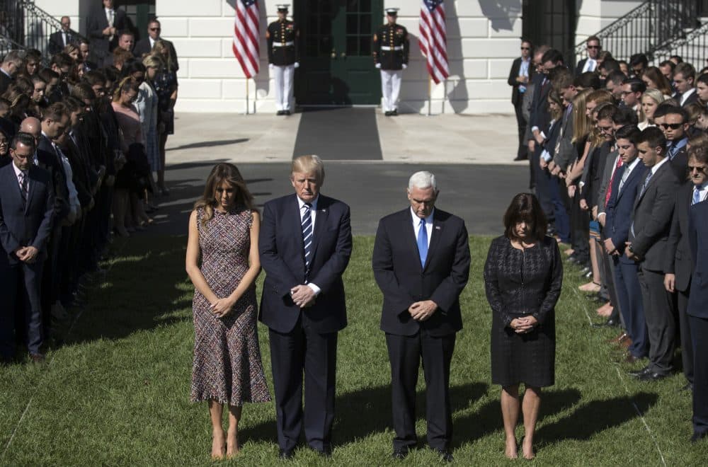 President Donald Trump and first lady Melania Trump stand with Vice President Mike Pence, his wife Karen and members of the White House staff, during a moment of silence to remember the victims of the mass shooting in Las Vegas, on the South Lawn of the White House in Washington, Monday, Oct. 2, 2017. (Carolyn Kaster/AP)