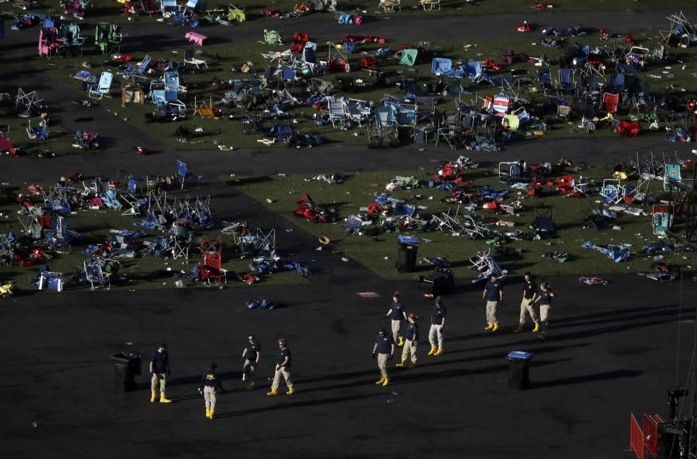 Investigators work at a festival grounds across the street from the Mandalay Bay Resort and Casino on Oct. 3 in Las Vegas. (Marcio Jose Sanchez/AP)