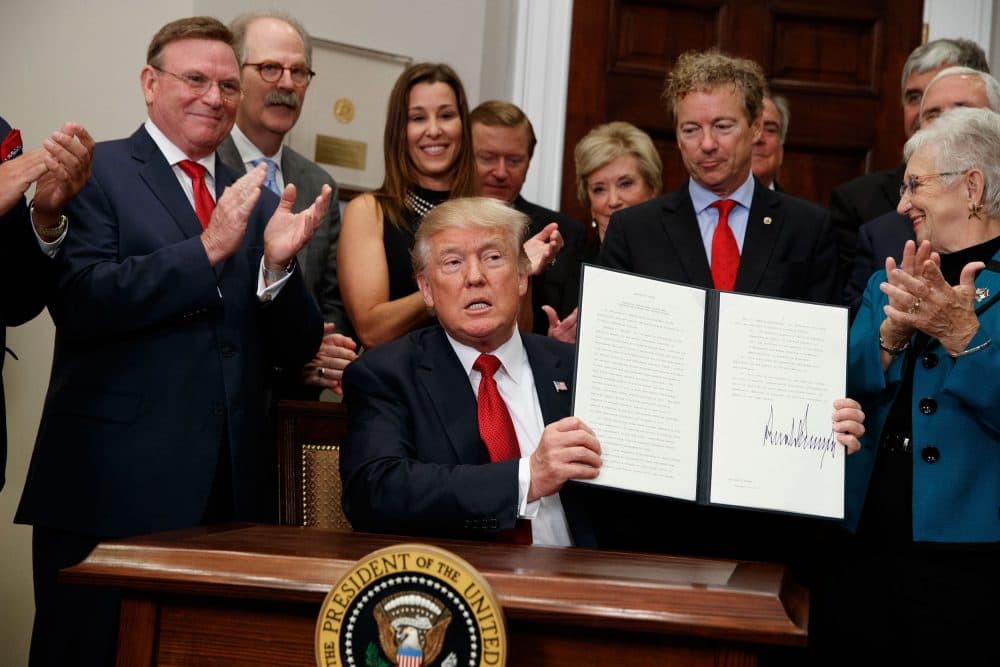 President Trump shows an executive order on health care that he signed in the Roosevelt Room of the White House on Oct. 12. Dave Ratner is second from left, behind Trump. (Evan Vucci/AP)
